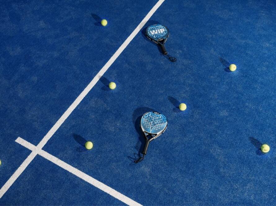 Padel vs tennis — rackets and balls on a padel court